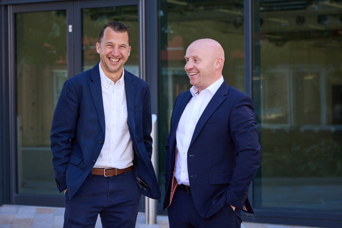 Ben Bradley and James Fieldhouse laughing outside HURST CF office